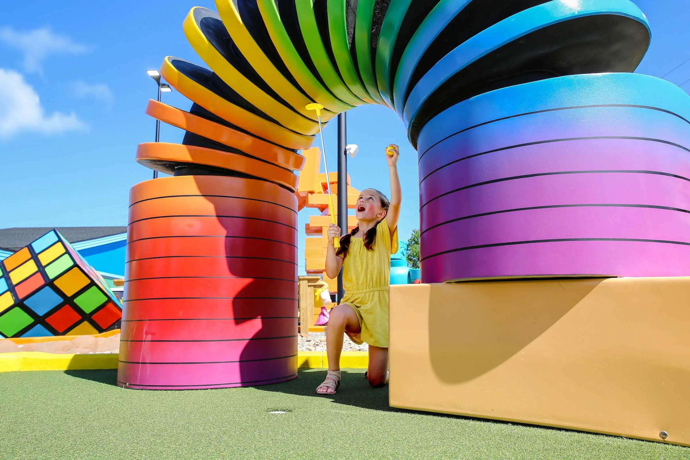 Girl with Slinky holding ball - zoomed out