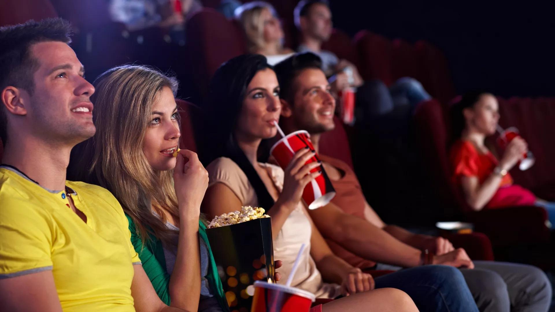 People in movie theatre watching movies