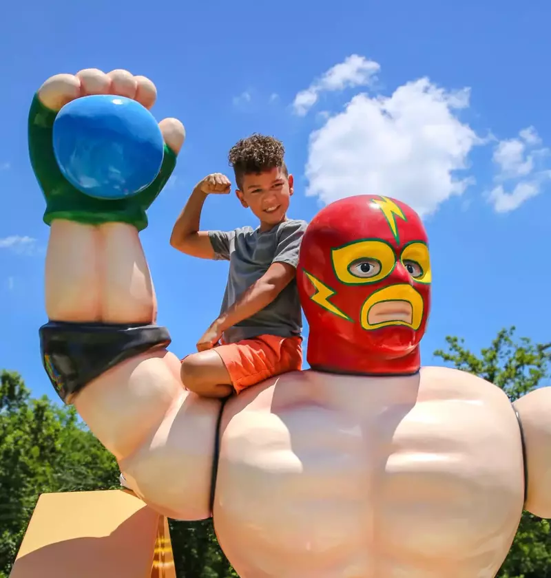 kid on shoulder of giant action figure