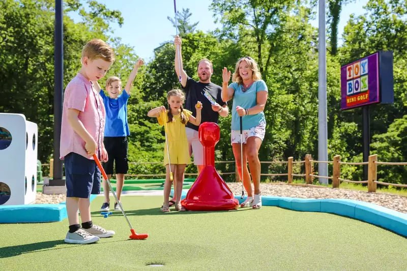 family playing mini golf