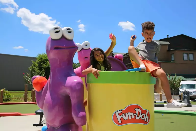 kids with toys at mini golf course