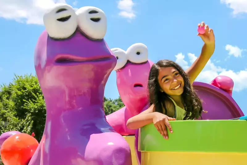 kid with toy at mini golf course