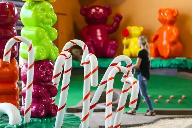 kid with giant candy canes